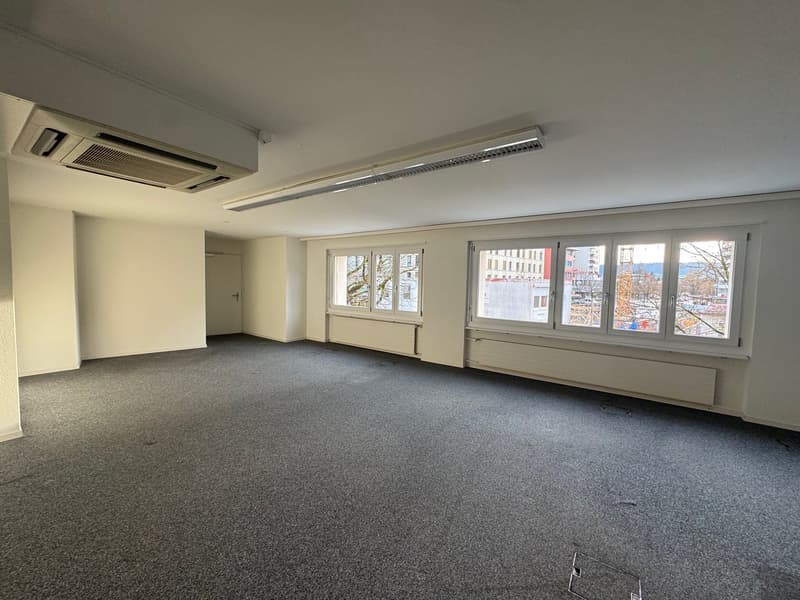 empty room, white walls, gray carpet, large windows, air conditioning unit, radiators