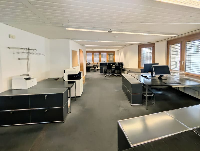 empty office with desks, chairs, computers, printer, windows, wooden doors