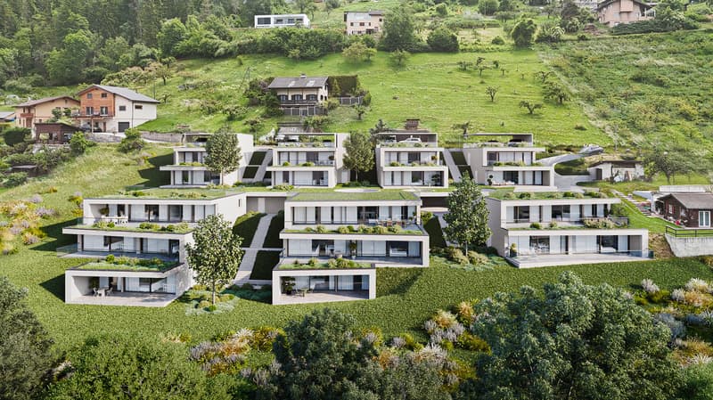 Modern apartment complex with green roofs, balconies, and raised ground floors
