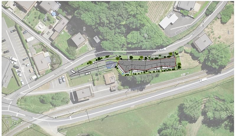 The image shows a site plan for a development project. It includes a residential area with multiple buildings, a parking lot, and surrounding green spaces and roads.