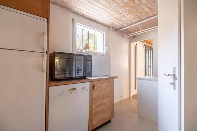 Wooden countertops, built-in dishwasher and washing machine, fridge, microwave, sink