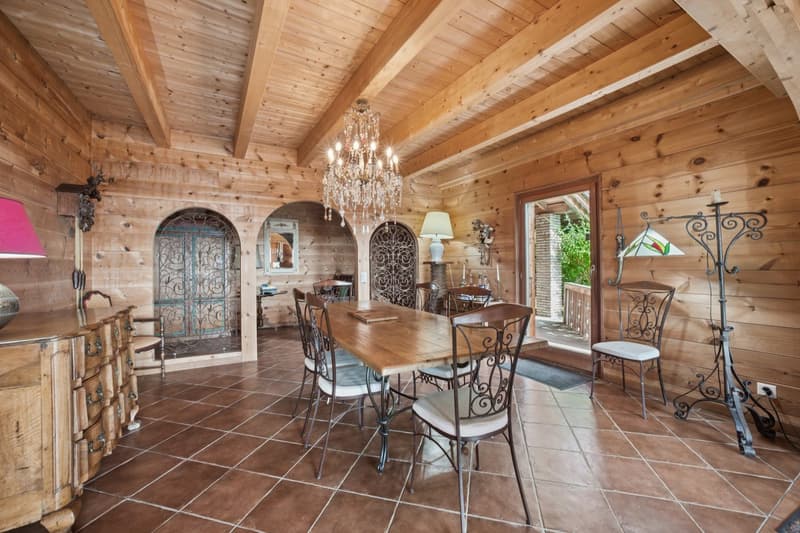 wooden walls, wooden floor, wooden dining table, chandelier, side tables, chair