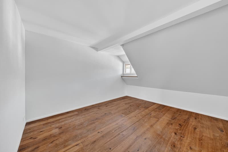 empty room, wooden floor, white walls, small attic window