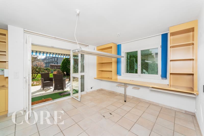 empty room, sliding door, balcony, wooden shelves, tiled floor, windows with blue curtains