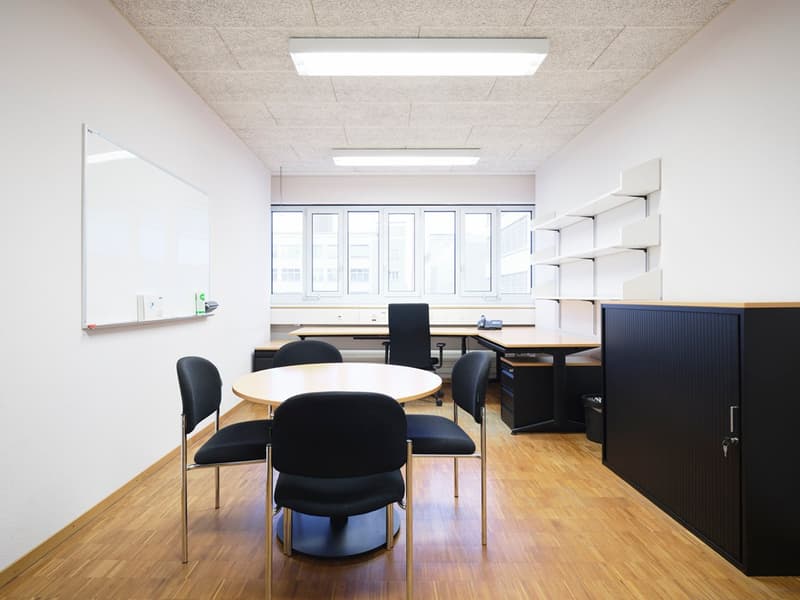modern office room with desk, chairs, whiteboard, shelves, hardwood floor, office lamp, large windows