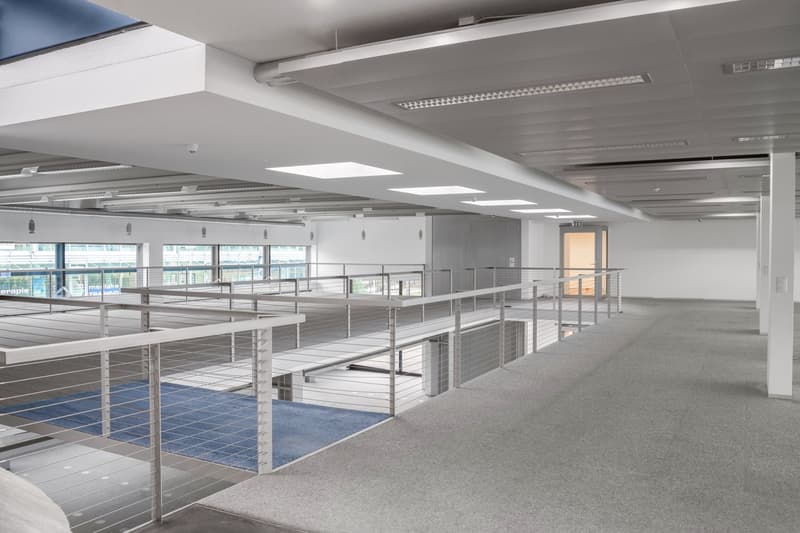 Empty floor with raised ground, large windows, glass railing, open balcony