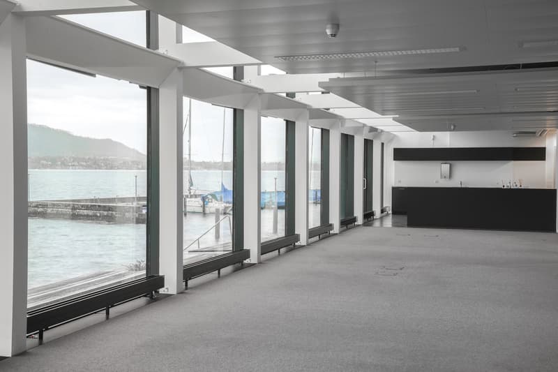 large windows with a view to the lake, wooden floor, white walls