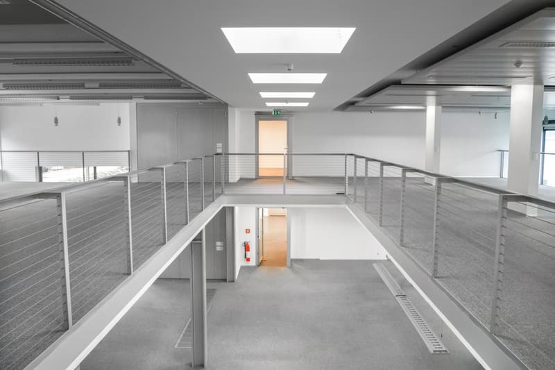 carpeted floors, metal railings, multiple exit doors, skylights, fire extinguisher