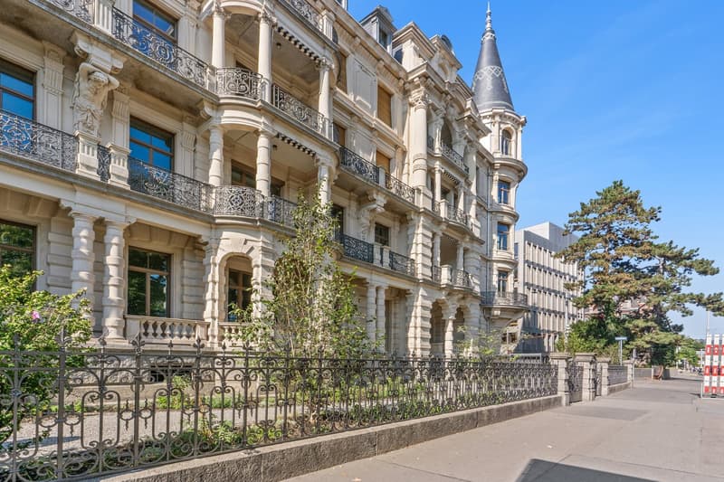 classical architecture, multiple levels, numerous balconies, turrets, white pillars, fencing