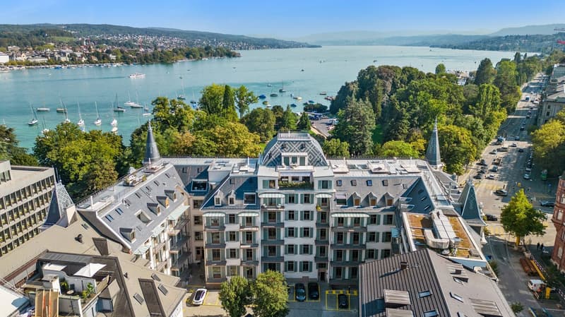 Luxury hotel with multiple floors, overlooking a bay and harbor