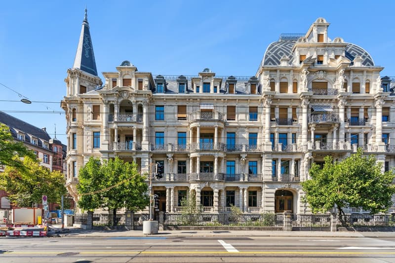 white stone building, many windows, towers, balconies