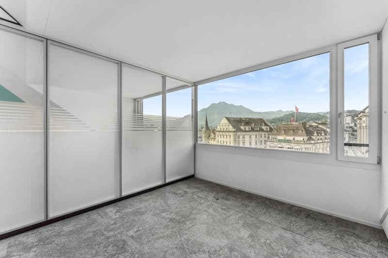 empty room, large windows, city view, mountains in the distance