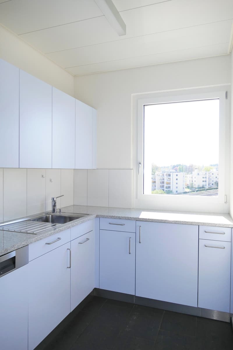 modern white kitchen, stainless steel sink, undermount cabinets, tiled floor, dishwasher, washing machine