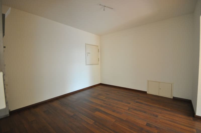 empty room, white walls, wooden floor, two white doors