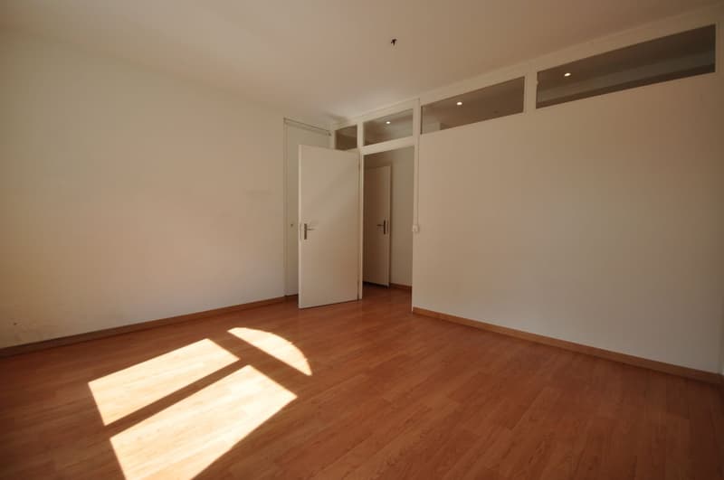 empty room, wooden floor, white walls, two doors, sunlight