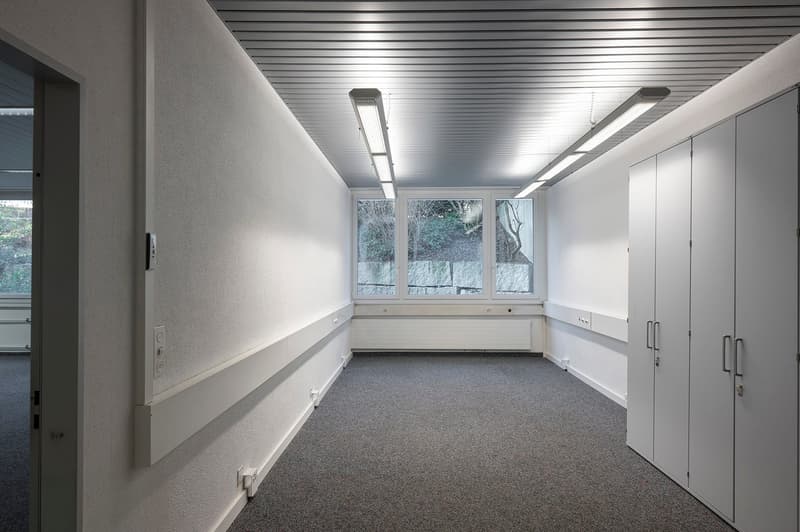 empty room, carpeted floor, recessed lighting, large windows, white walls, cabinets, power outlets