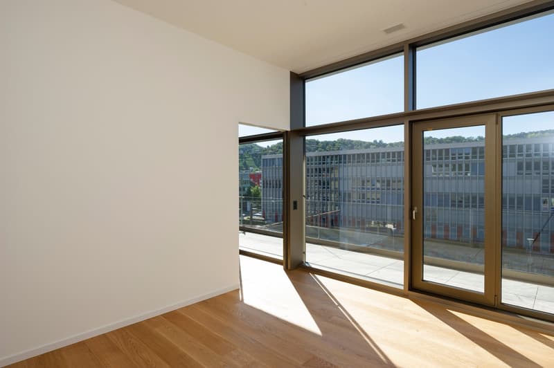 modern room with hardwood floor, large windows, glass door leading to balcony, city view