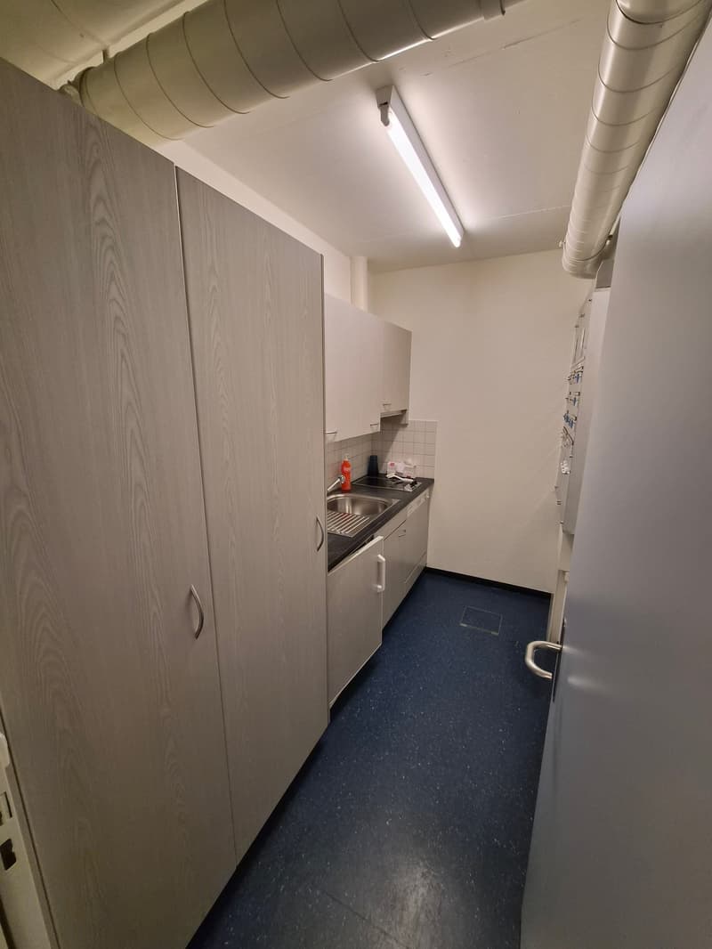 empty kitchen with sink, cabinets, dishwasher, and a refrigerator