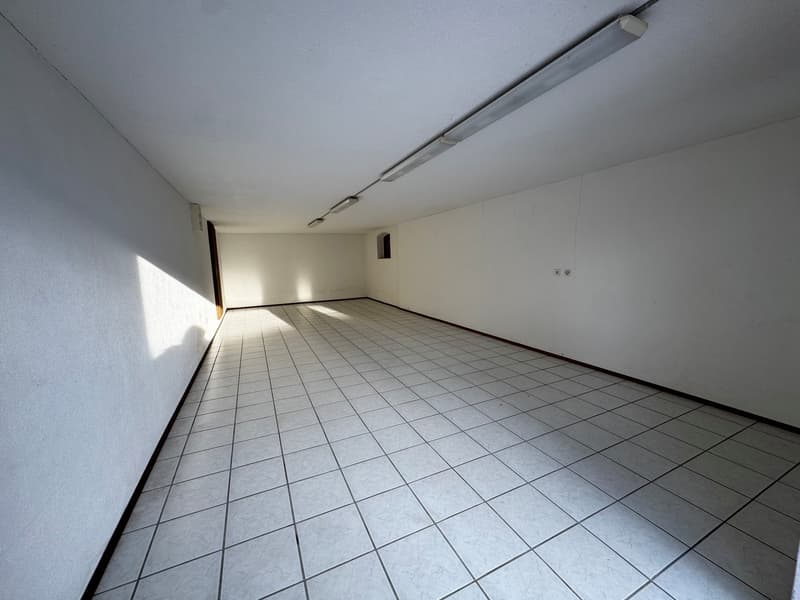 white tiled floor, white walls, ceiling with lights