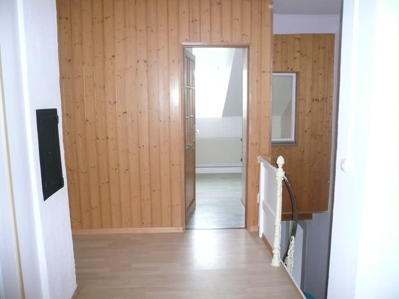 empty hallway, wooden walls, wooden flooring, mirror on the wall