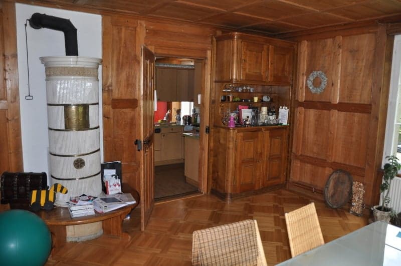 wooden floor, wooden walls, fireplace, desk, chairs, potted plant, globe, wooden door, kitchen entrance