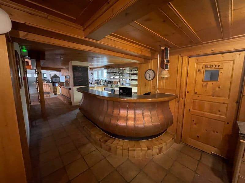interior with wooden counter, wooden ceiling, tiled floor, a desk and monitor in the back