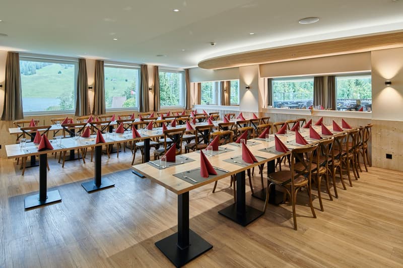 Restaurant: wooden floors, large windows, wooden tables, wooden chairs, wooden tables, wine glasses