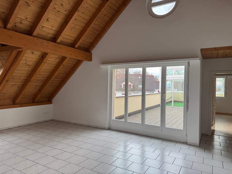 empty room with white tiles, balcony with glass doors, wooden ceiling