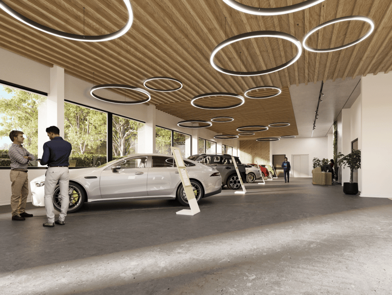 modern design, large windows, wooden ceiling, cars on display, circular lights, concrete floor