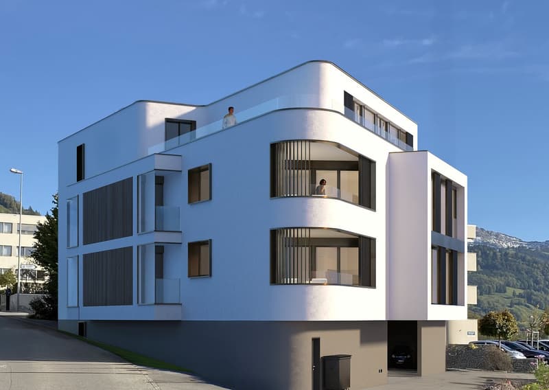 Modern white building, large windows, balconies, mountains in the background