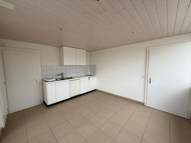 tiled floor, white cabinets, stainless steel sink, faucet, white tiled wall, dishwasher