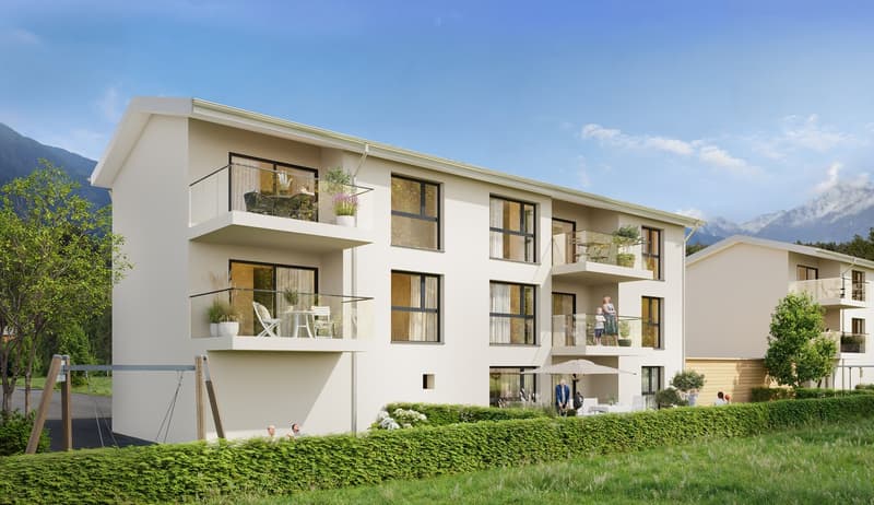 Modern white apartment building, multiple balconies, large windows, open green area, playground, distant mountains