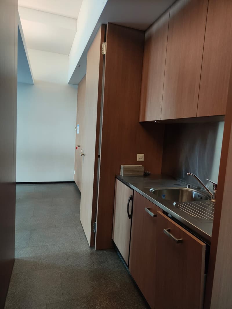 Modern kitchen, wooden cabinets, tile floor, granite countertop, stainless steel sink with faucet