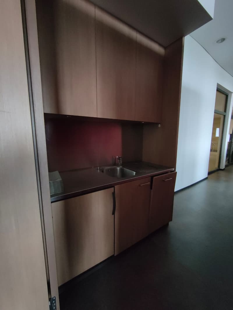 small kitchen, wooden cabinets, stainless steel sink, countertop, cabinets below