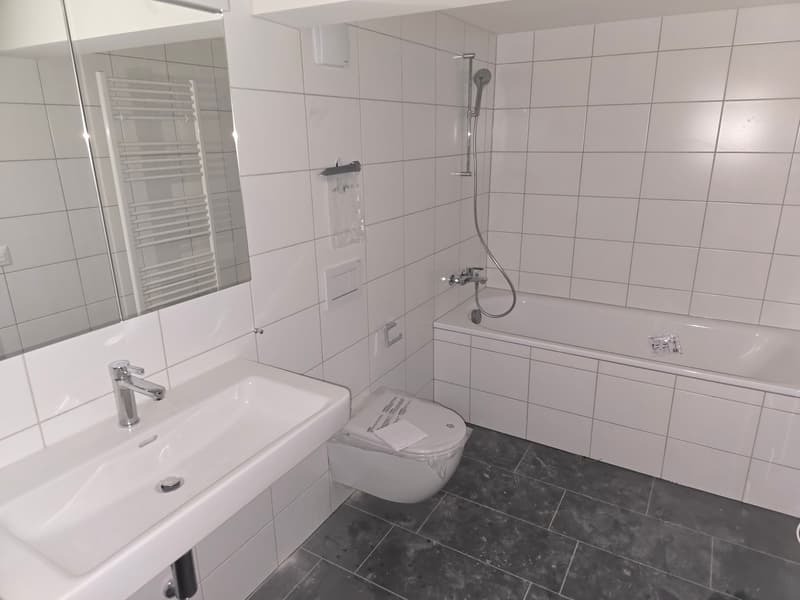 Bathroom with white tiles, white sink, white toilet, white bathtub, glass-door shower