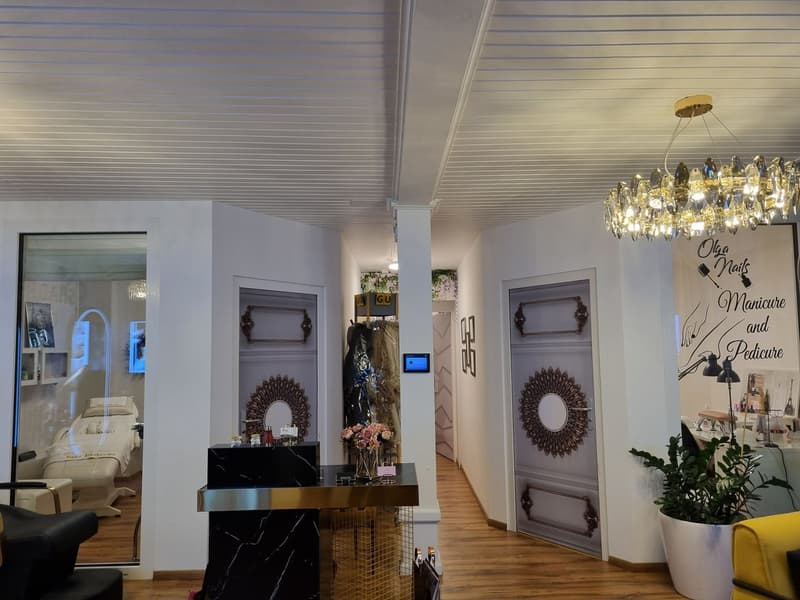 modern interior design, chandelier, marble counter, glass door, bed in the mirror, desk, potted plant, lamps