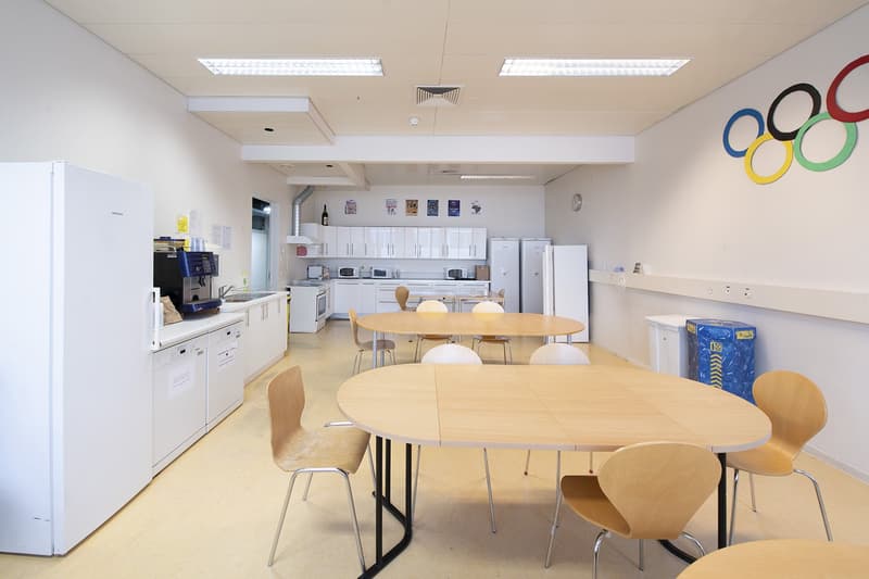 a kitchen with a sink, refrigerator, and microwave