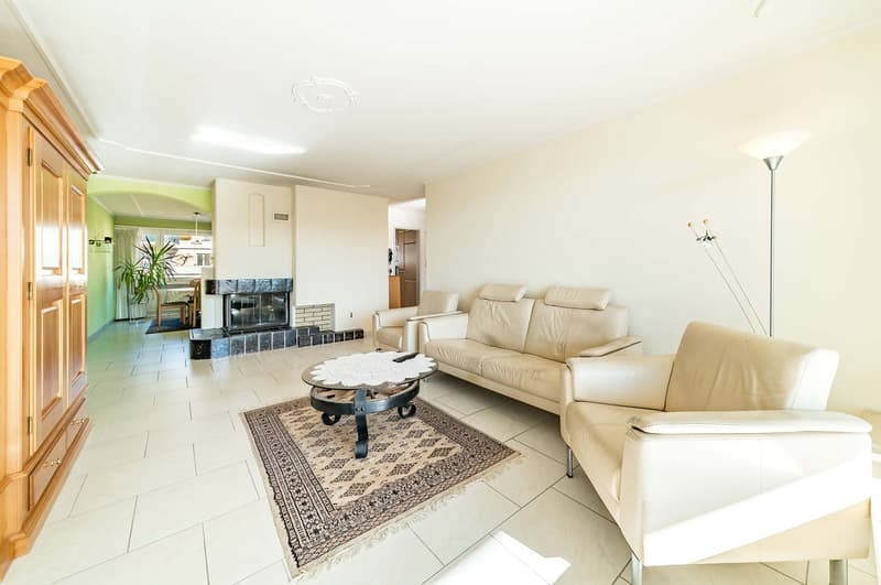 white walls, white tile flooring, fireplace, white leather couches, coffee table, rug, floor lamp