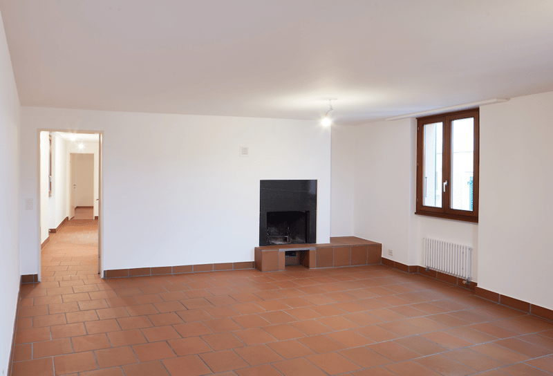 empty room, fireplace, white walls, red tile floor, radiator