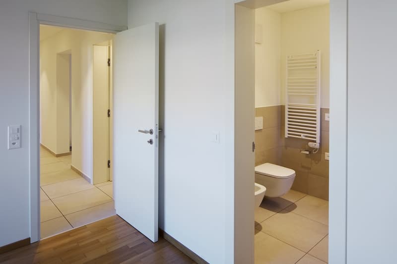 Bathroom with toilet, bidet, and towel rack