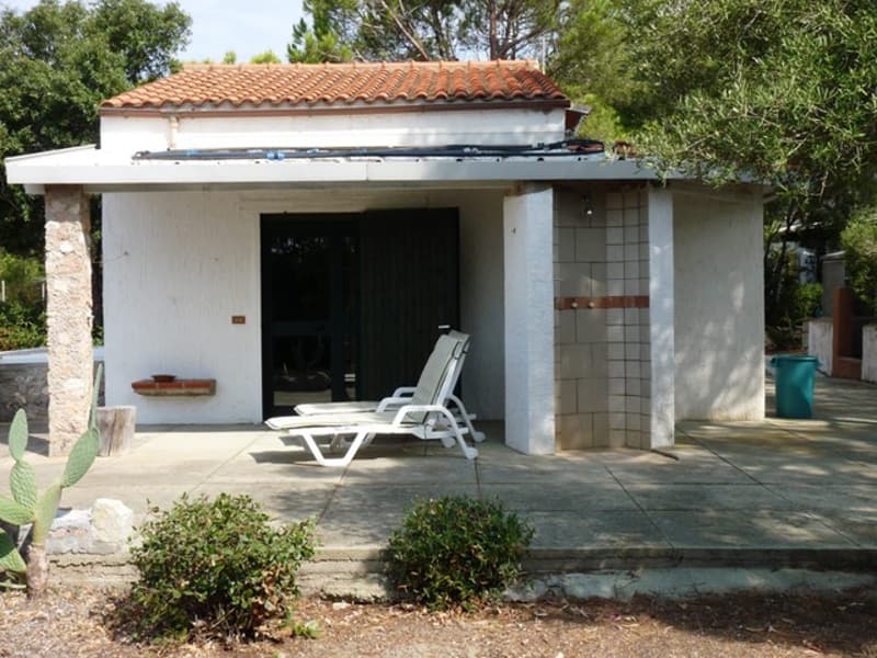 detached villa, red roof, white walls, patio with lounge chairs, exterior shower
