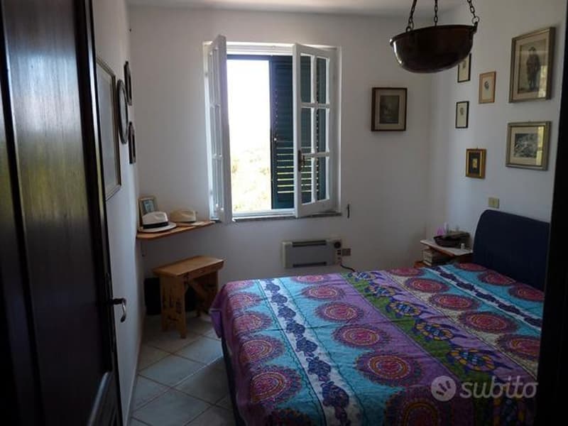 queen size bed, window, bedspread, wooden table, decorative items, tiles
