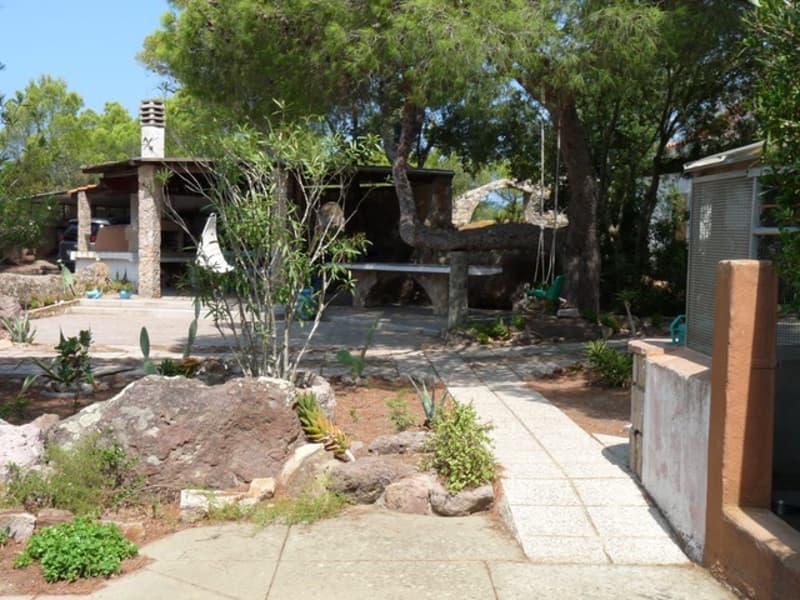 Small rural house, fireplace, small garden, trees, pathway, rocks