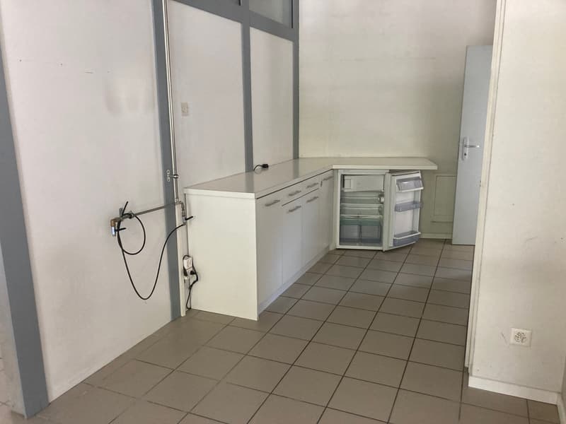 white cabinets, tiled floor, small fridge, washing machine, dishwasher, power outlets