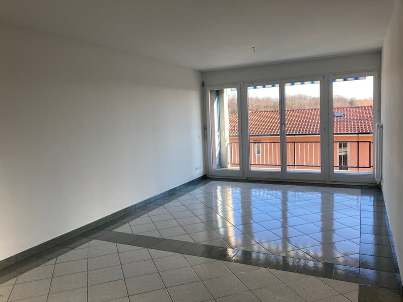 empty room with large glass door leading to balcony, tiled floor