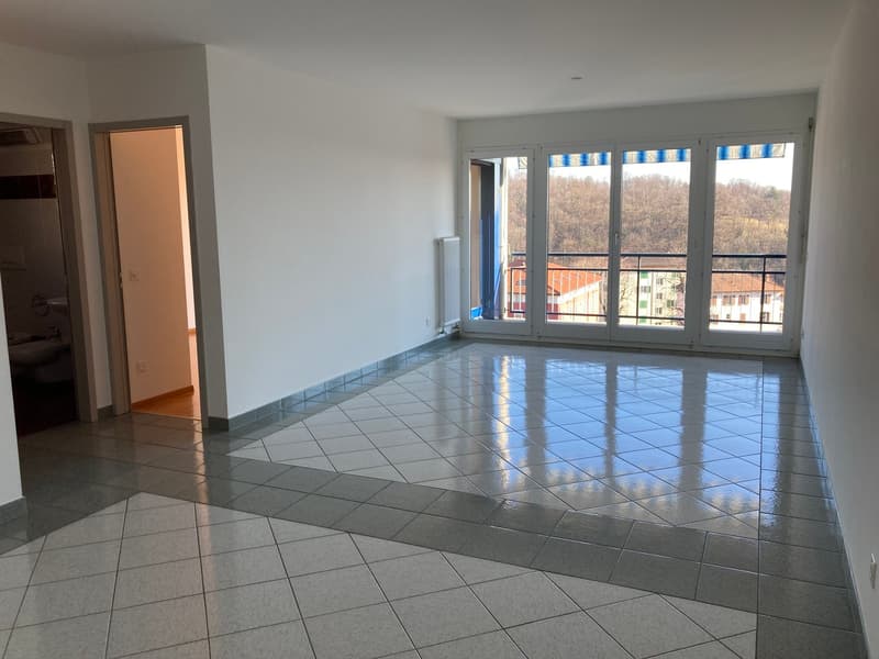 empty room, sliding glass doors to balcony, tiled floor, white walls, heater