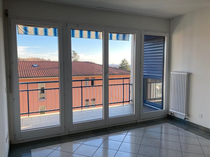 glass door with balcony, white radiator, white tiles