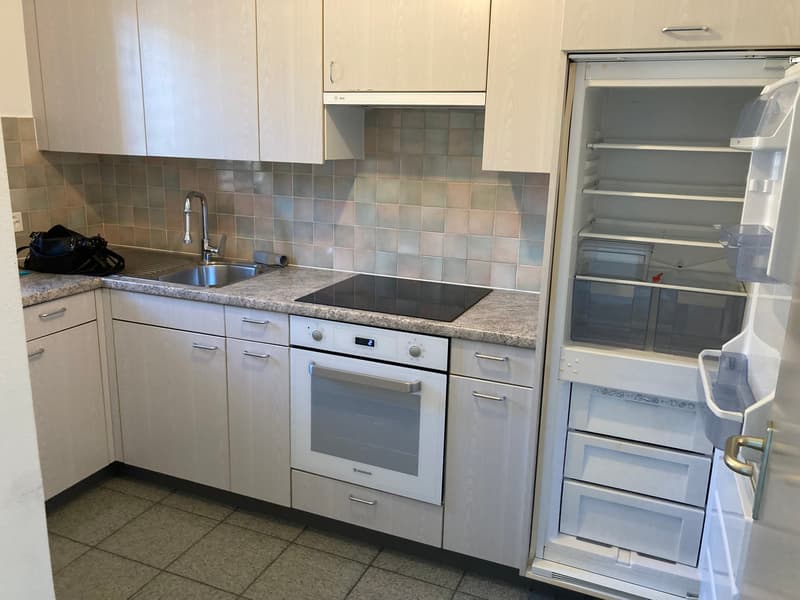 modern kitchen, white cabinets, granite countertops, stainless steel appliances, open refrigerator