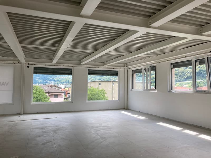 empty room, white walls, tiled floor, large windows, view of trees and buildings