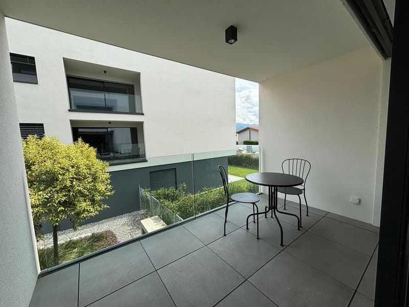 Terrace with outdoor furniture and glass railing